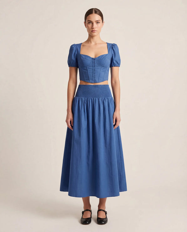 THE NOVA SHIRRED WAIST MAXI SKIRT IN BLUE