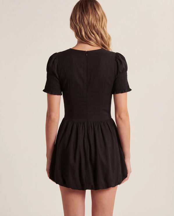 THE MIRA SMOCKED BUBBLE MINI DRESS IN BLACK
