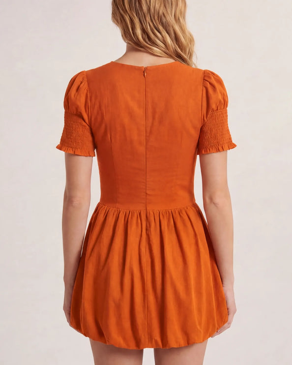 THE MIRA SMOCKED BUBBLE MINI DRESS IN ORANGE