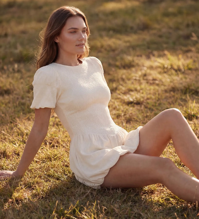 THE MIRA SMOCKED BUBBLE MINI DRESS IN WHITE