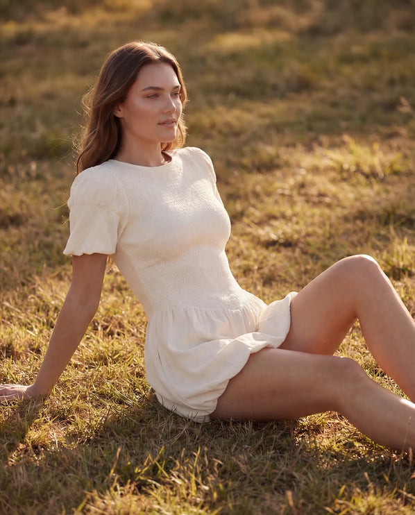 THE MIRA SMOCKED BUBBLE MINI DRESS IN WHITE