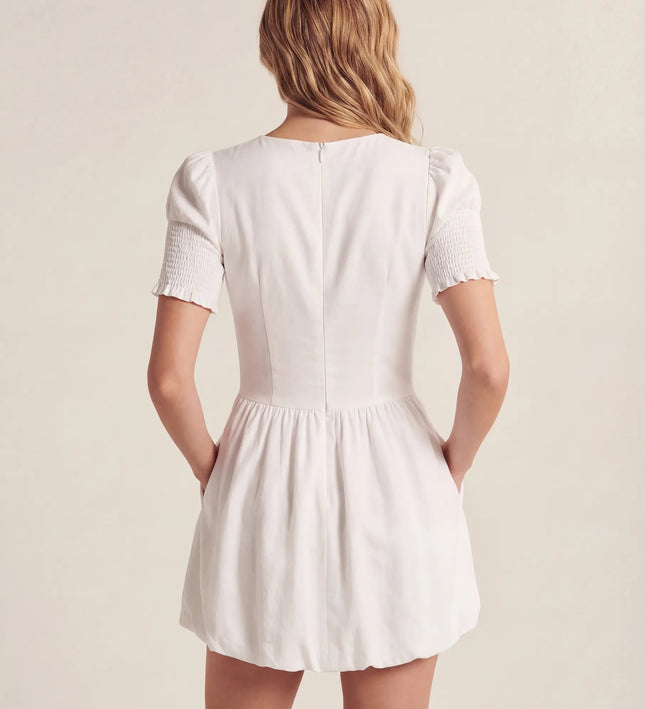 THE MIRA SMOCKED BUBBLE MINI DRESS IN WHITE