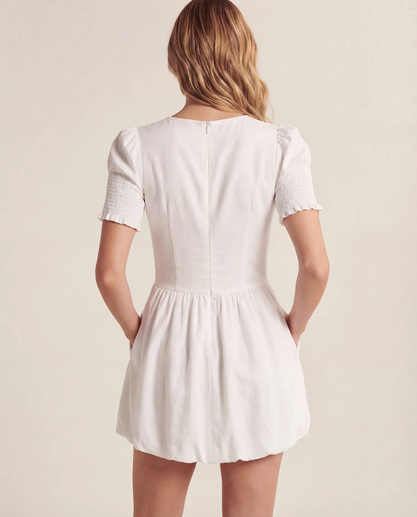 THE MIRA SMOCKED BUBBLE MINI DRESS IN WHITE
